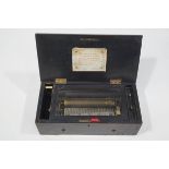 A 19th Century Swiss musical box in an ebonised case, playing six airs on a 19cm barrel case,