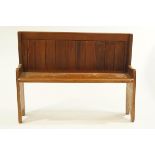 A small late Victorian stained pine settle,