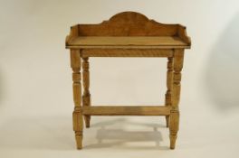 An early 20th Century painted pine wash stand, with turned legs, gallery back and undershelf,