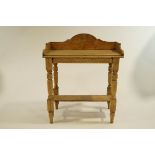 An early 20th Century painted pine wash stand, with turned legs, gallery back and undershelf,