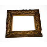 An ornate giltwood picture frame, with Classical markings of swags and 'C' scrolls,