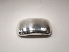 A silver pocket snuff box, concave oblong with a hinged cover,