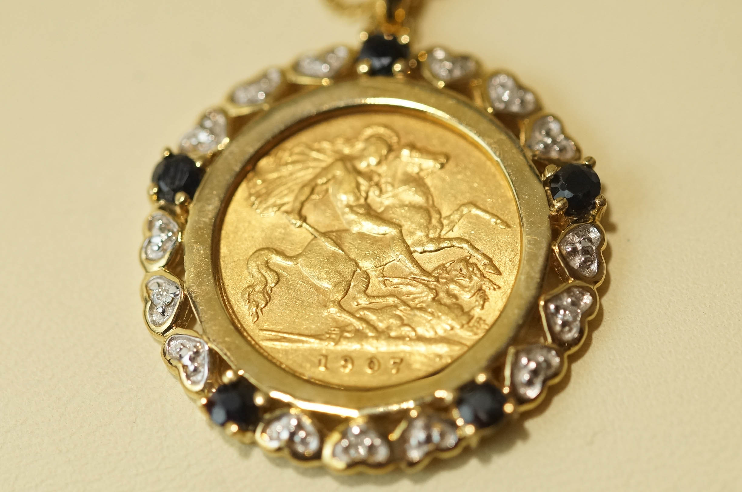 A 1907 half Sovereign, in a 9 carat gold sapphire and diamond pendant mount, on a chain, 11. - Image 3 of 3