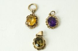 A collection of three 9 carat gold stone set pendants; 4.
