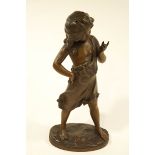 A large spelter figure of a playful young girl, formerly a lamp with drilled holes,