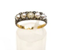 A late Victorian graduated pearl five stone carved half-hoop ring with rose diamon points,