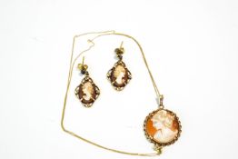 A pair of 9 carat gold shell cameo earrings; and a shell cameo pendant on a chain,