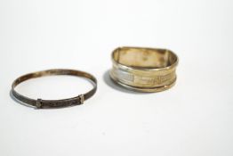 A silver napkin ring; and a silver child's bracelet; 17.