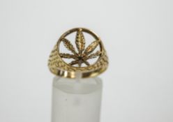 A 9 carat gold ring, with a pierced Cannabis leaf to the head, finger size S, 4.