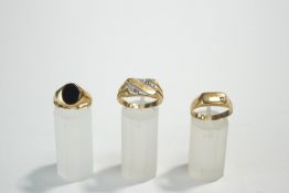 A 9 carat gold onyx signet ring; with two other 9 carat gold signet rings;