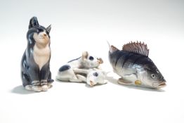Three Royal Copenhagen models, pig group, a seated cat, and a fish,