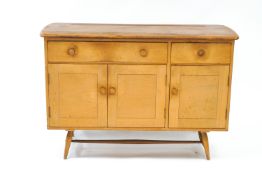 A small Ercol beech and elm sideboard, with two drawers over a cupboard base,