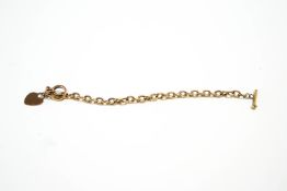 A bracelet, tagged '375', of hollow oval links, with a 9 carat gold heart charm attached,