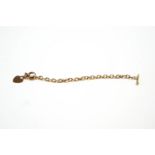 A bracelet, tagged '375', of hollow oval links, with a 9 carat gold heart charm attached,