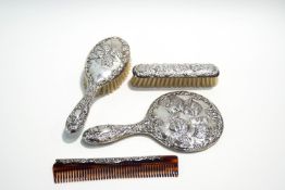 A Victorian style silver backed four piece dressing brush set, Birmingham 1977,