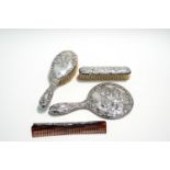 A Victorian style silver backed four piece dressing brush set, Birmingham 1977,