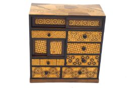 A 20th century specimen wood and parquetry table cabinet,