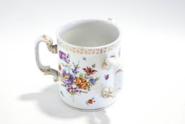 A Dresden style three handled Tyg, hand painted with flowers,