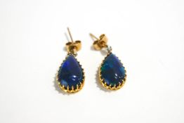 A pair of black Opal and diamond drop earrings, the tear shaped cabochons approximately 13.