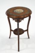 An Edwardian mahogany two tier occasional table, with hand painted Classical decoration,