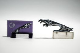 A small chrome Jaguar car mascot and a further similar one with Goodwood plaque