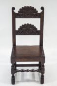 A 17th Century and later carved oak hall chair