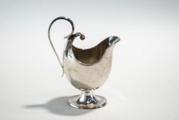 A Silver cream jug by Walker & Hall, Sheffield 1904, of unusual helmet shape, 11cm high, 73g (2.