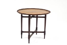 A 20th century mahogany gate-leg table, with piecrust top,