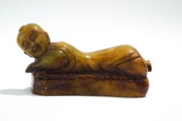 A Chinese carved soapstone recumbent figure,