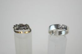 A three stone paste set silver ring;