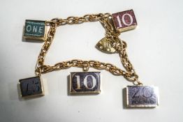 A 9 carat gold bracelet, of fancy links, with a 10 shilling, one pound, five pound, ten pound,