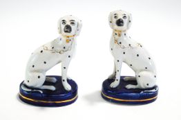 A pair of Staffordshire seated Dalmation dogs,
