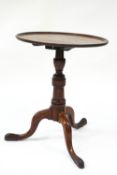 A Georgian mahogany snap top table on pad feet,