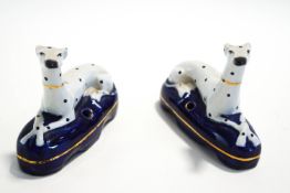 A pair of Staffordshire recumbent Dalmation dog pen holders,