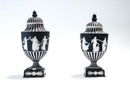 A near pair of Jasperware urns and covers, on pedestal bases,