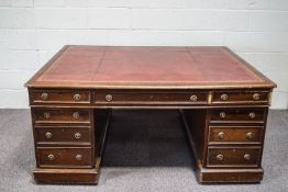 A Victorian mahogany partners desk, with tooled red leather writing surface,