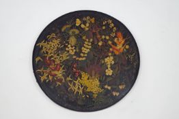A 19th Century painted and lacquered circular table top/tray decorated with flora and fauna,