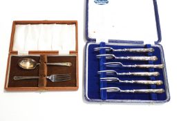 A cased Silver spoon and fork set, 36g gross, with a cased set of six cake forks,