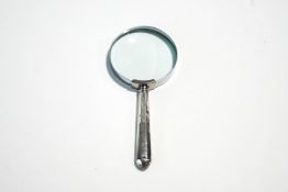 A magnifying glass, with a loaded silver handle, 14.