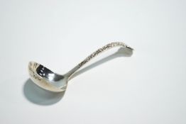A silver sauce ladle, Sheffield 1973, with Celtic design in relief, 11.5 cm long, 24.