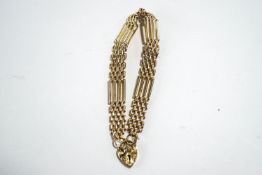 A 9 carat gold bracelet, of four bar gate link design, to a padlock clasp, 10.