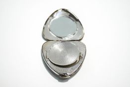 A Kigu silver compact, London 1960, of almost heart shape,