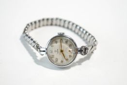 Tudor, a lady's steel wrist watch, the round white dial with gilt Arabic numerals and hands,