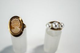 A 9 carat gold shell cameo ring; with a three stone cultured pearl 9 carat gold ring;