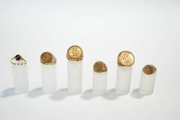 A Mexican pesos mounted 9 carat gold ring; four 9 carat gold rings,