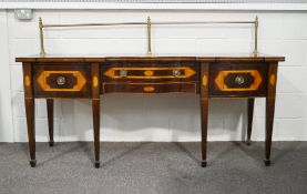 A 19th century mahogany sheraton style sideboard, with a brass rail back,