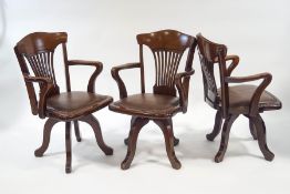A set of three mahogany swivel office chairs each with pierced splats