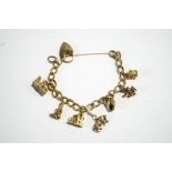 A 9 carat gold bracelet, of curb links, to a padlock clasp, with seven charms attached, 28.