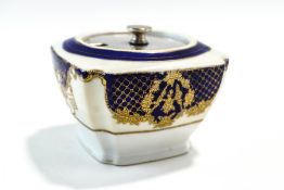 A Noritake jam pot, with gilt decoration over a cobalt blue and cream ground,