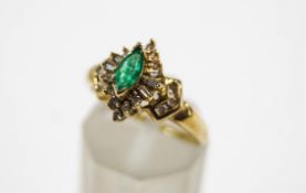 An emerald and diamond cluster ring, stamped '10K',